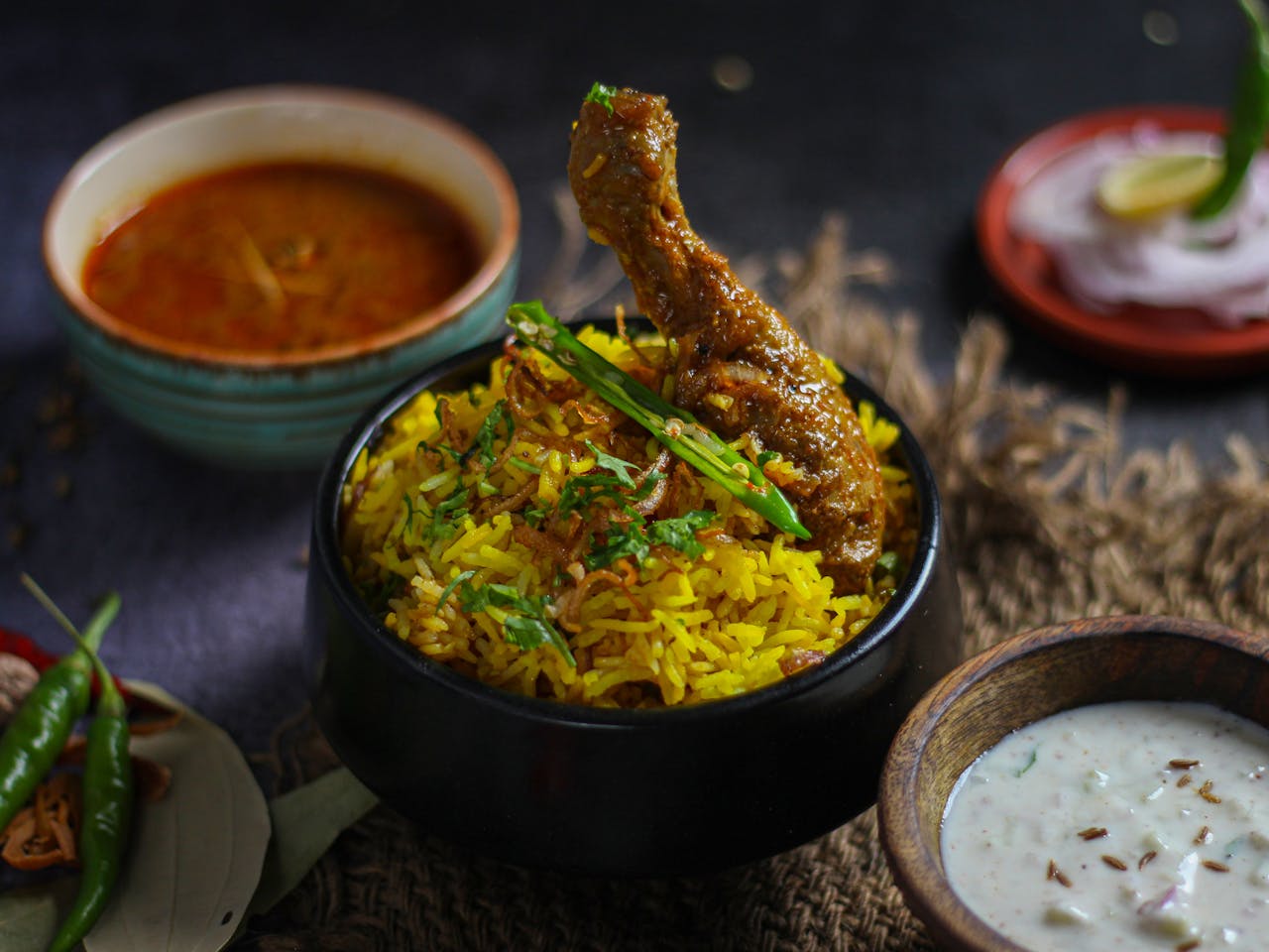services-02 Delicious chicken biryani served with traditional Indian condiments, capturing vibrant flavors and spices.